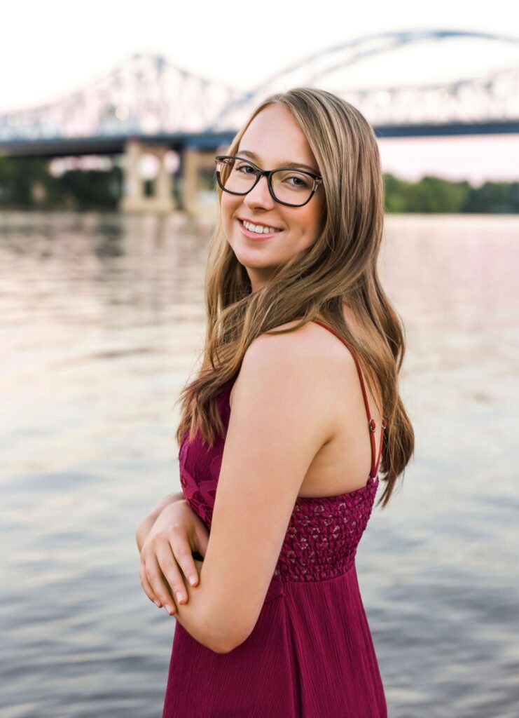 photo of Alexis standing in front of the Mississippi and she is a digital marketer passionate about climate activism